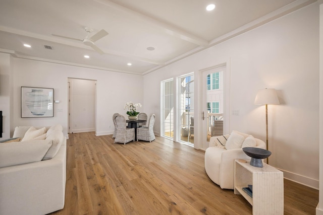 living room with hardwood / wood-style flooring, beamed ceiling, and ceiling fan