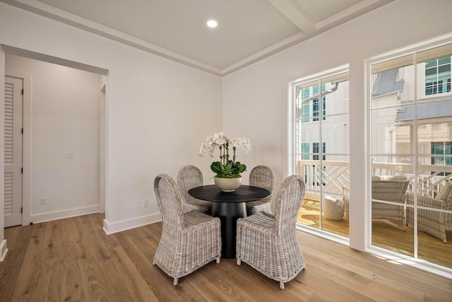 dining room with beamed ceiling and hardwood / wood-style floors