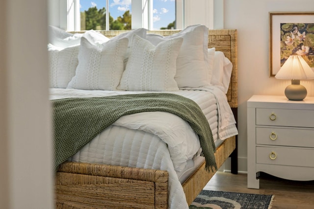 bedroom with dark hardwood / wood-style floors