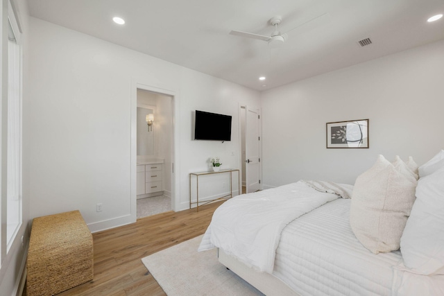 bedroom featuring connected bathroom, light hardwood / wood-style floors, and ceiling fan