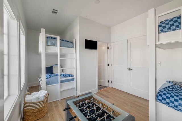 kitchen with light hardwood / wood-style flooring and white cabinetry