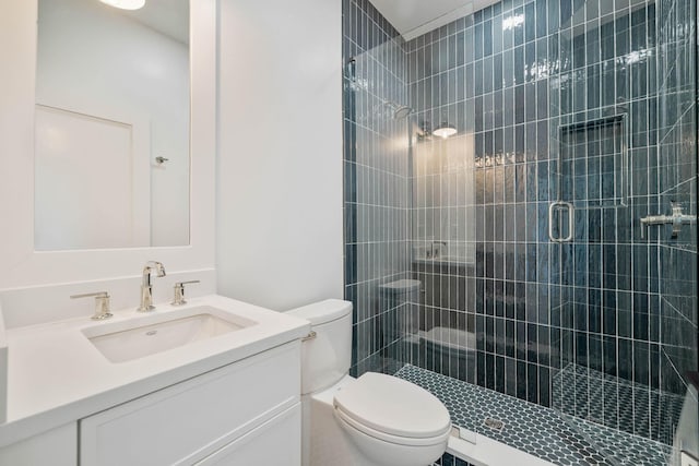 bathroom featuring vanity, toilet, and an enclosed shower