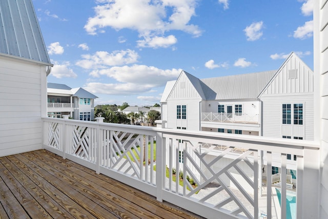 wooden terrace featuring a swimming pool