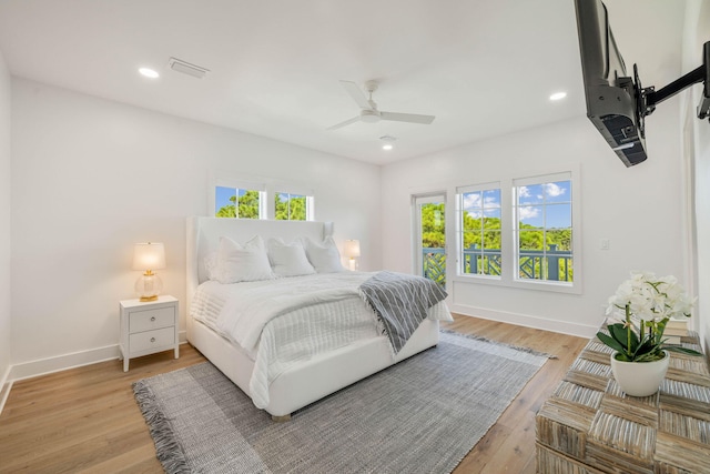 bedroom with ceiling fan and light hardwood / wood-style flooring