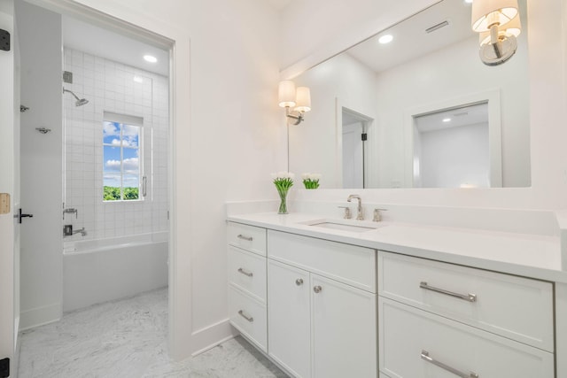 bathroom with vanity and tiled shower / bath