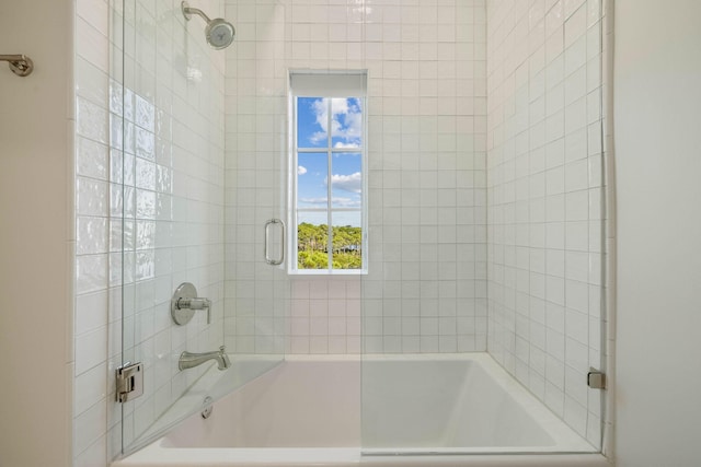 bathroom featuring bath / shower combo with glass door