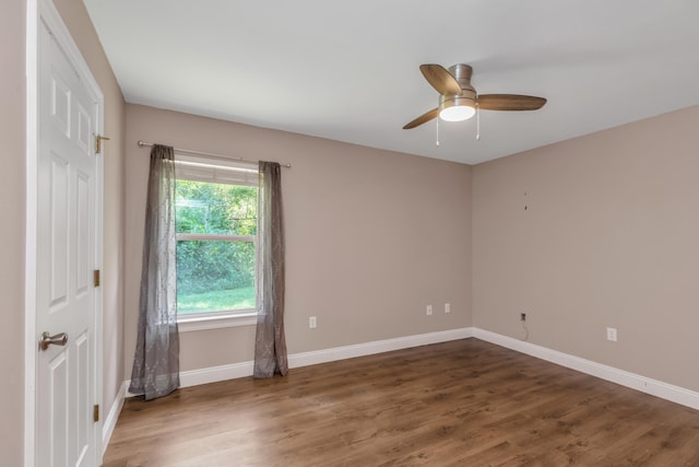 spare room featuring ceiling fan and dark hardwood / wood-style floors