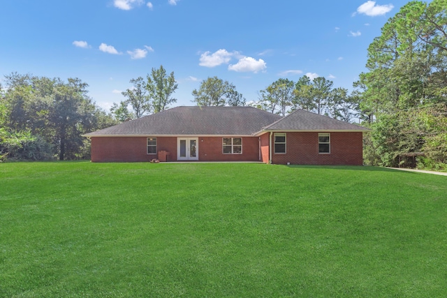 rear view of house featuring french doors and a yard