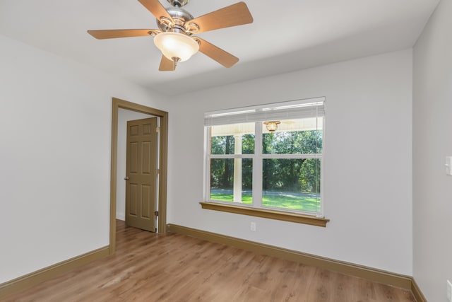 empty room with ceiling fan and light wood-type flooring