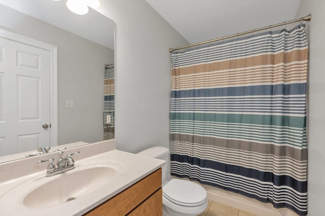 bathroom with tile patterned floors, walk in shower, vanity, and toilet