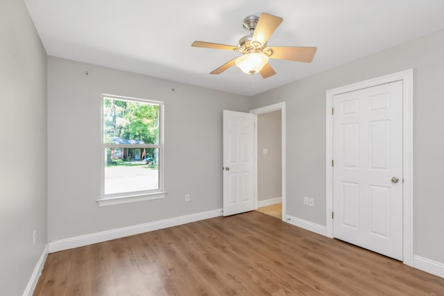 unfurnished bedroom with ceiling fan and light hardwood / wood-style floors