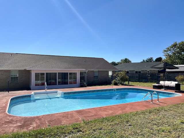 view of pool featuring an outdoor hangout area, a patio, fence, and a fenced in pool
