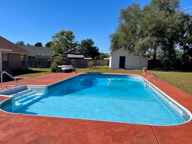 view of pool featuring a yard and an outdoor structure