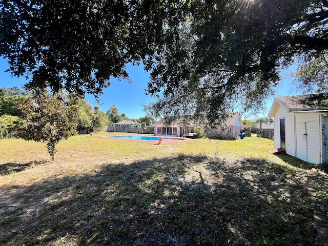 view of yard with a fenced in pool