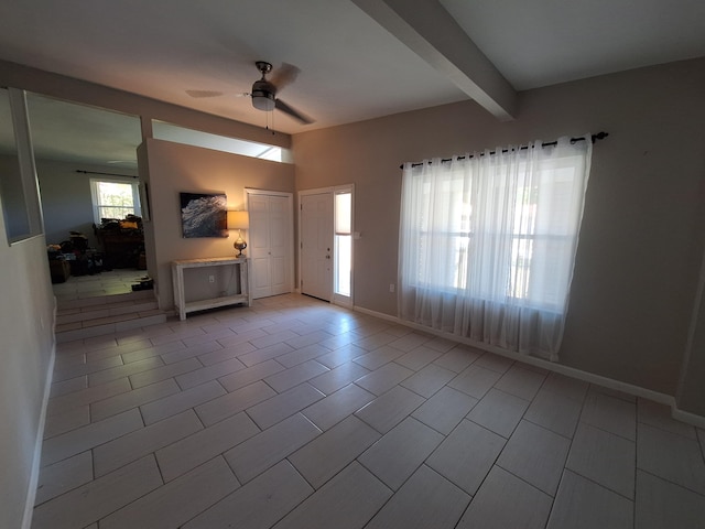 tiled foyer featuring beam ceiling and ceiling fan