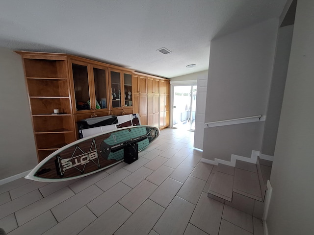 interior space with a textured ceiling and lofted ceiling