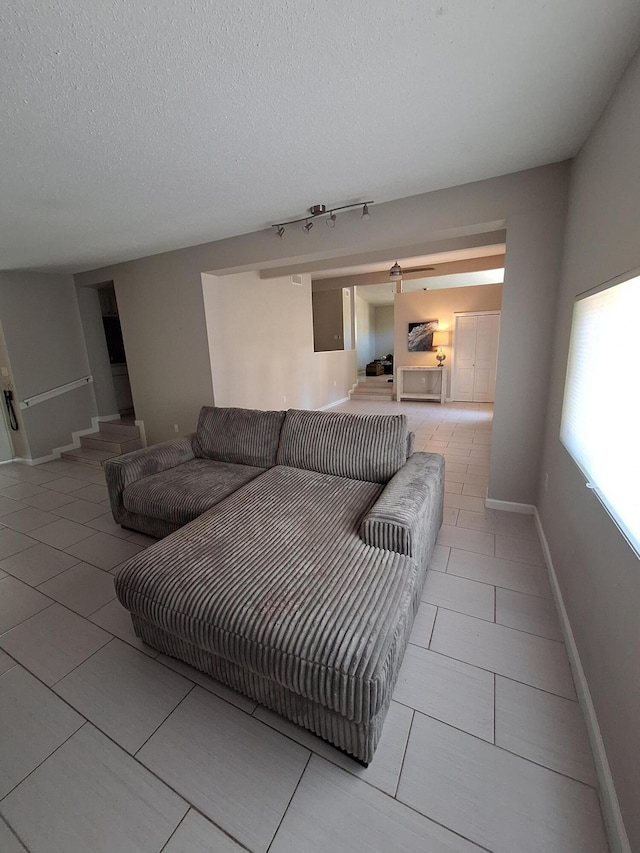 tiled living room with a textured ceiling