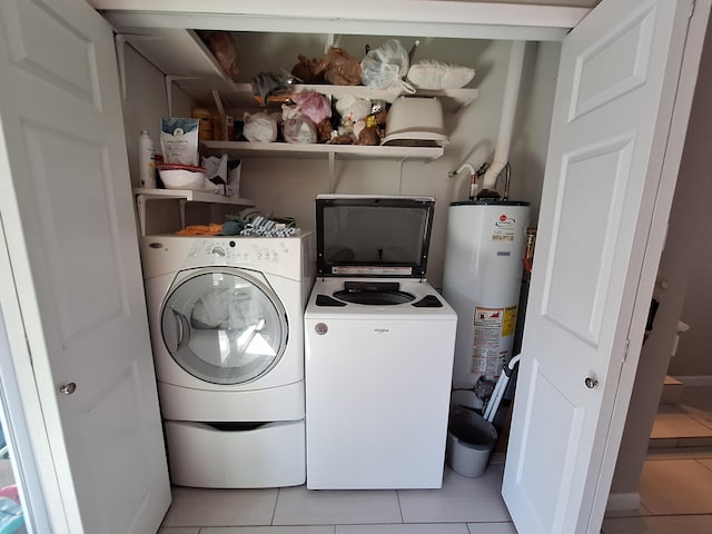 washroom with light tile patterned flooring, separate washer and dryer, and water heater