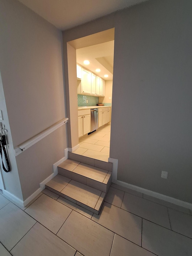 stairway with tile patterned flooring