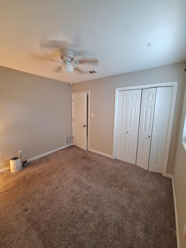 unfurnished bedroom featuring ceiling fan and carpet