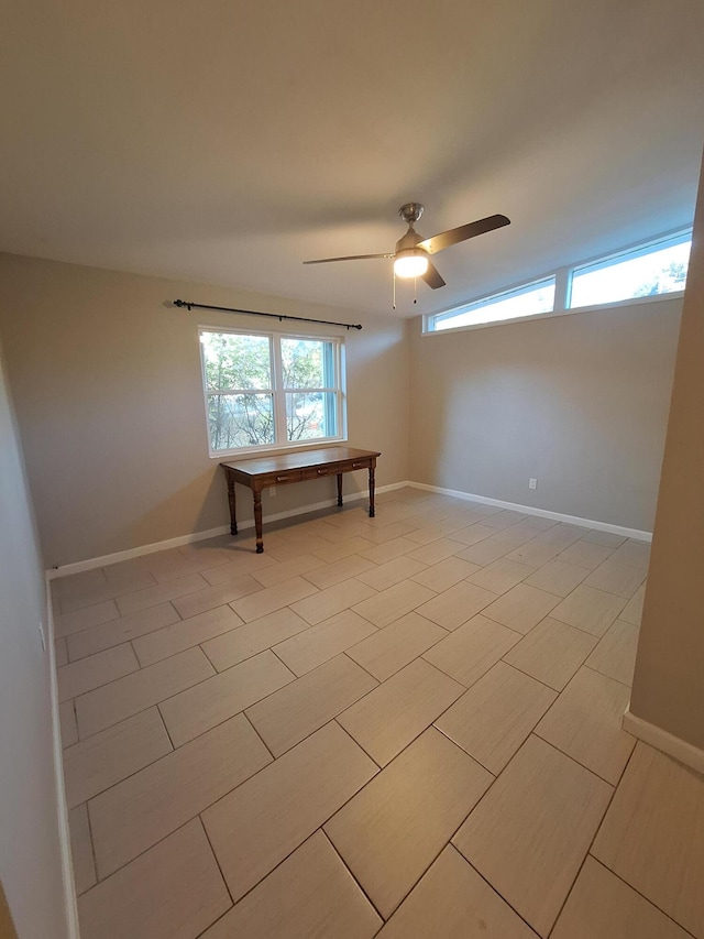 tiled empty room with ceiling fan