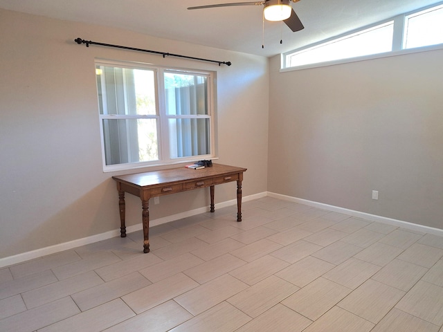 interior space featuring a ceiling fan and baseboards