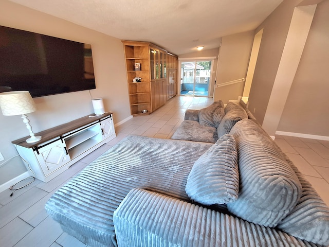 living area featuring baseboards