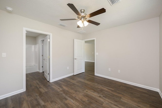 unfurnished bedroom featuring ceiling fan, a textured ceiling, and dark hardwood / wood-style floors