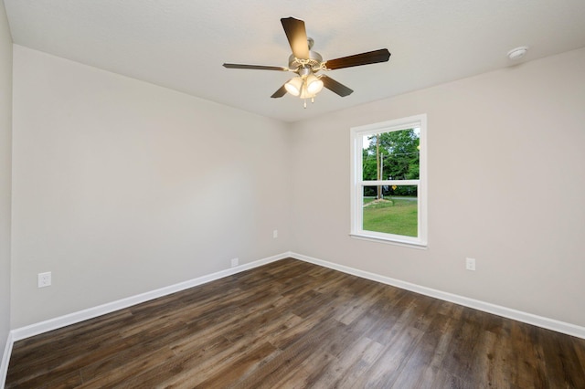 spare room with dark wood-type flooring and ceiling fan