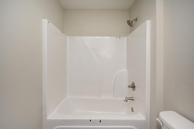 bathroom featuring toilet and shower / bathtub combination