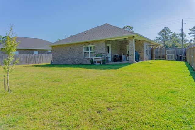 rear view of house featuring a lawn