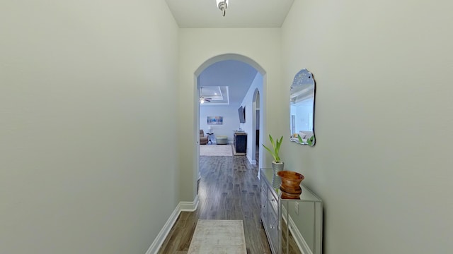 hallway with dark hardwood / wood-style flooring