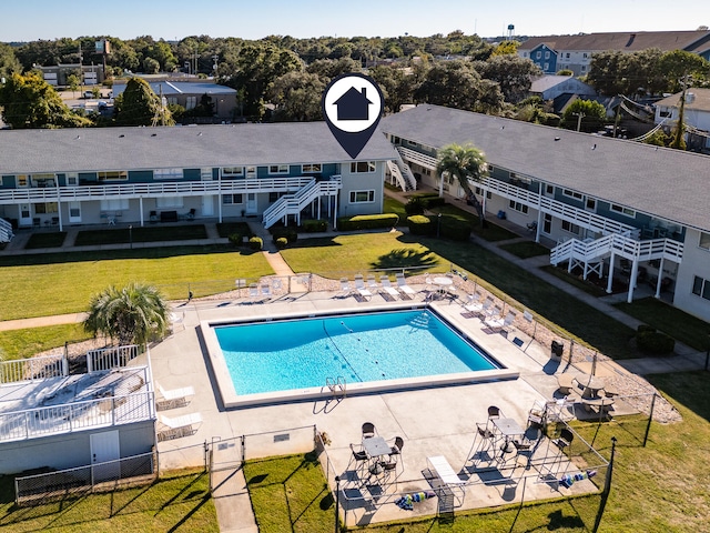 view of swimming pool featuring a patio area and a lawn