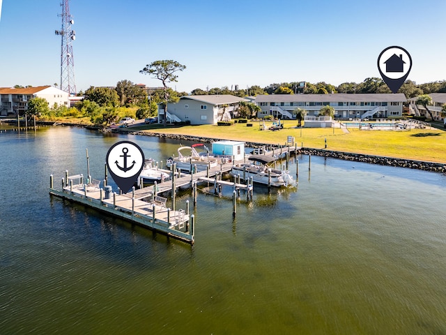 view of dock with a lawn and a water view