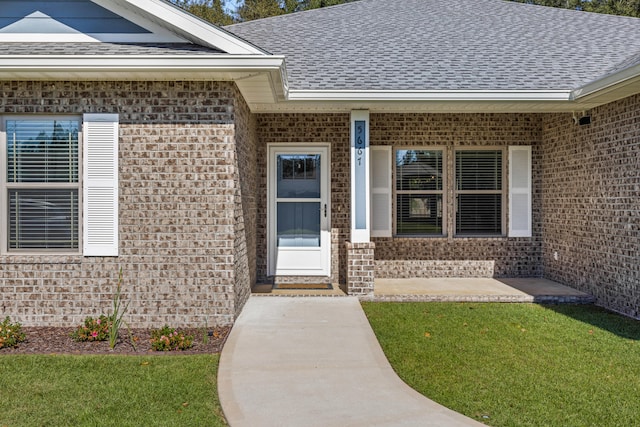 property entrance with a lawn