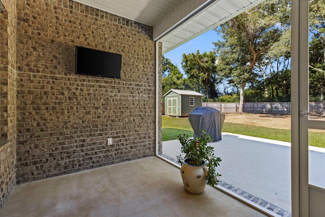 view of patio / terrace featuring grilling area and a storage shed