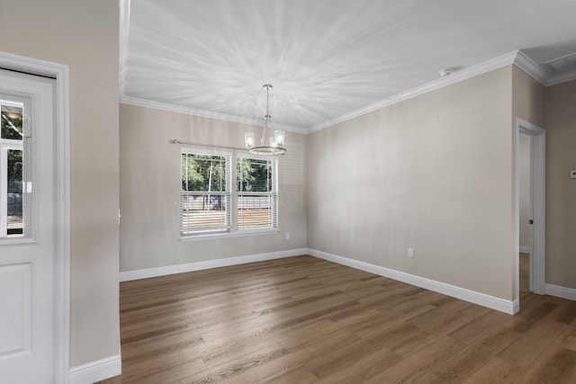 unfurnished dining area with ornamental molding, dark wood-type flooring, and a notable chandelier