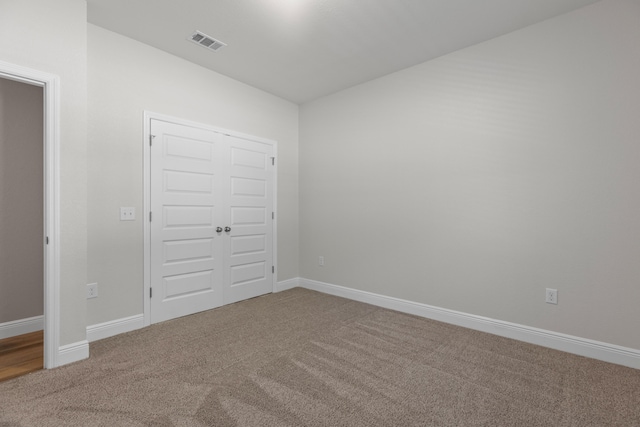 unfurnished bedroom featuring carpet and a closet