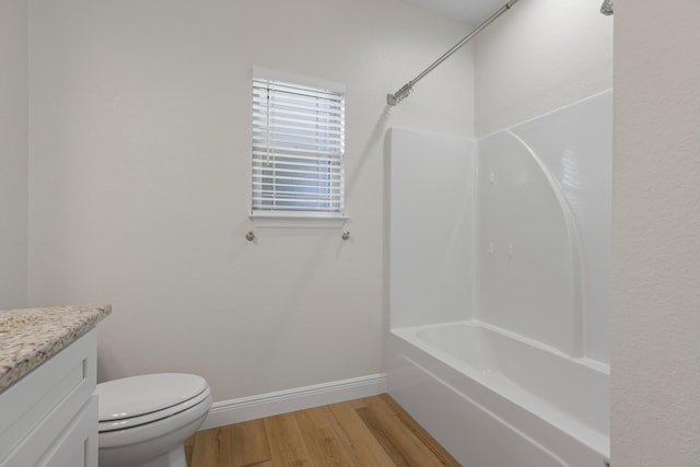 full bathroom featuring bathing tub / shower combination, toilet, vanity, and hardwood / wood-style flooring