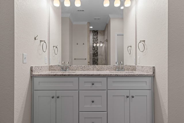 bathroom featuring a shower, vanity, and crown molding