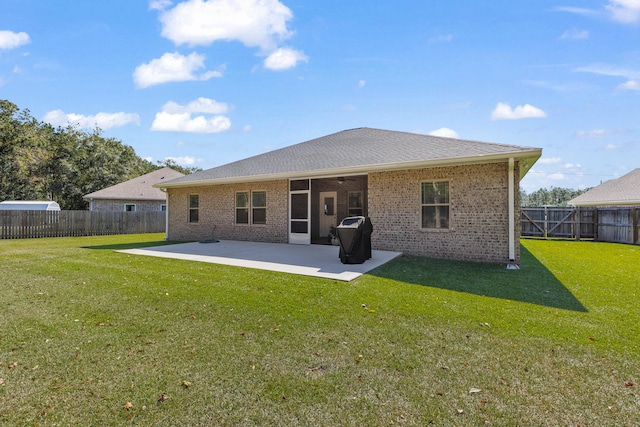 rear view of property featuring a yard and a patio area