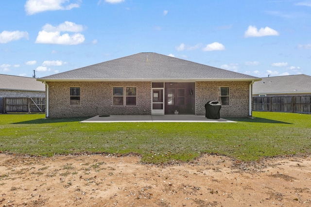 back of house with a lawn and a patio area