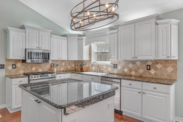 kitchen featuring appliances with stainless steel finishes, a center island, and white cabinets