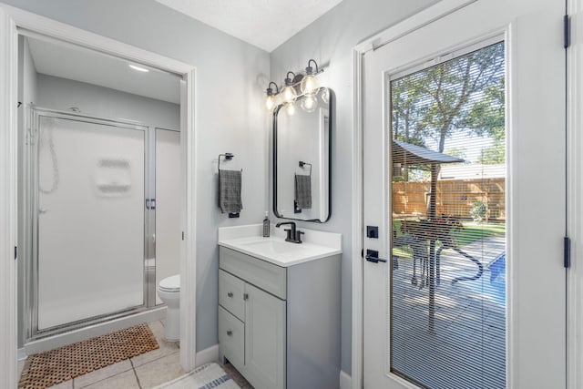 bathroom featuring a shower with door, a textured ceiling, toilet, vanity, and tile patterned flooring