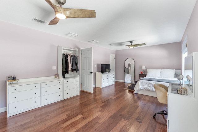 bedroom with dark hardwood / wood-style floors, a closet, and ceiling fan