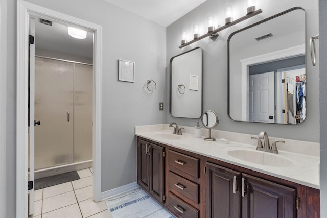 bathroom with vanity, walk in shower, and tile patterned floors