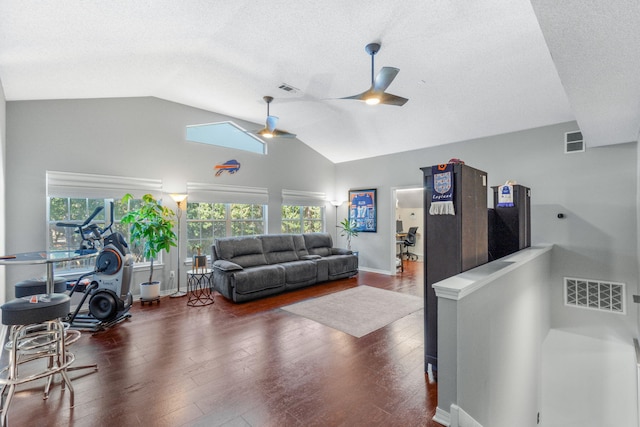 living room with ceiling fan, vaulted ceiling, and dark hardwood / wood-style flooring