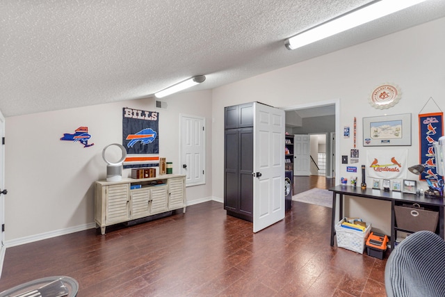 office area with lofted ceiling, a textured ceiling, and dark wood-type flooring