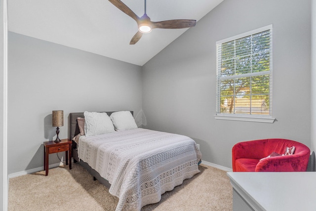 bedroom with ceiling fan, light colored carpet, and vaulted ceiling