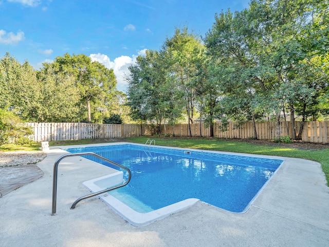 view of swimming pool with a patio area and a lawn